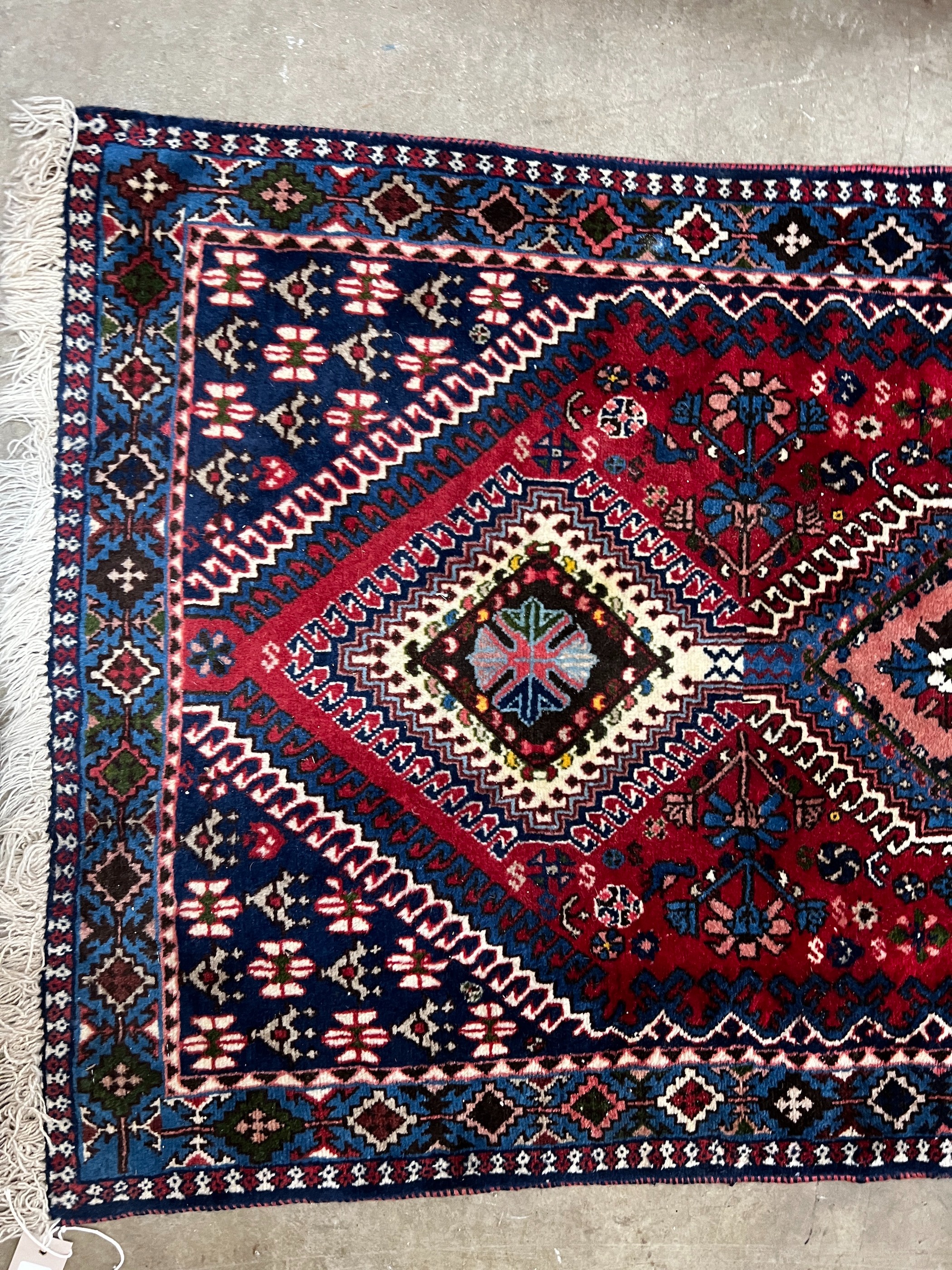 A Caucasian style red ground runner 200cm x 76cm